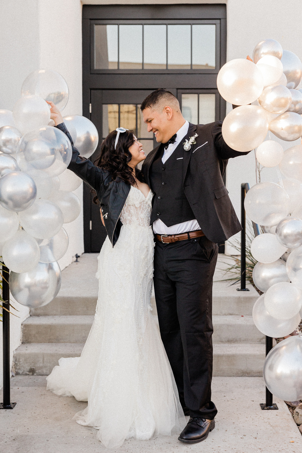 Newlywed Couple Holding Silver Balloons